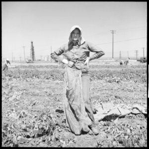 Kern County, California. Migrant youth in potato field. This is a characteristic costume of women in the potato... - NARA - 532140 photo