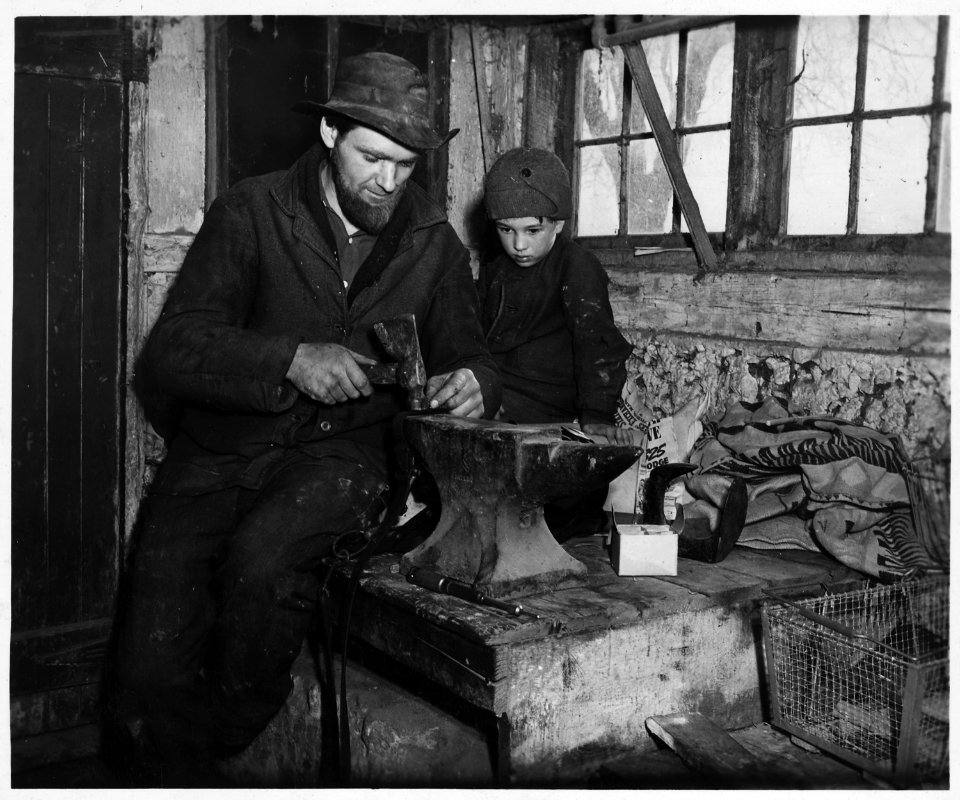 Lancaster County, Pennsylvania. This Old-Order Amish farmer is mending a harness. Mustaches are ne . . . - NARA - 521065