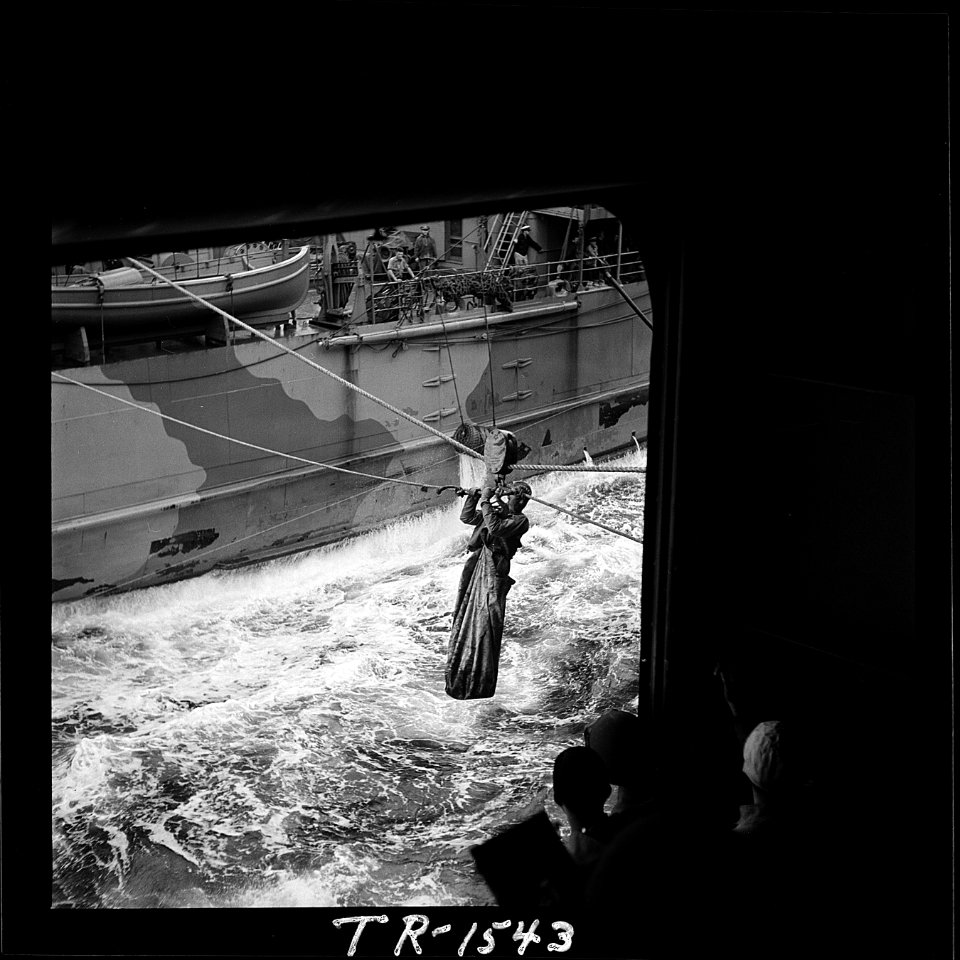 Lcdr. J.T. Blackburn being transferred by breeches buoy from a tanker to the USS Santee (CVE-29) in the Atlantic... - NARA - 520870
