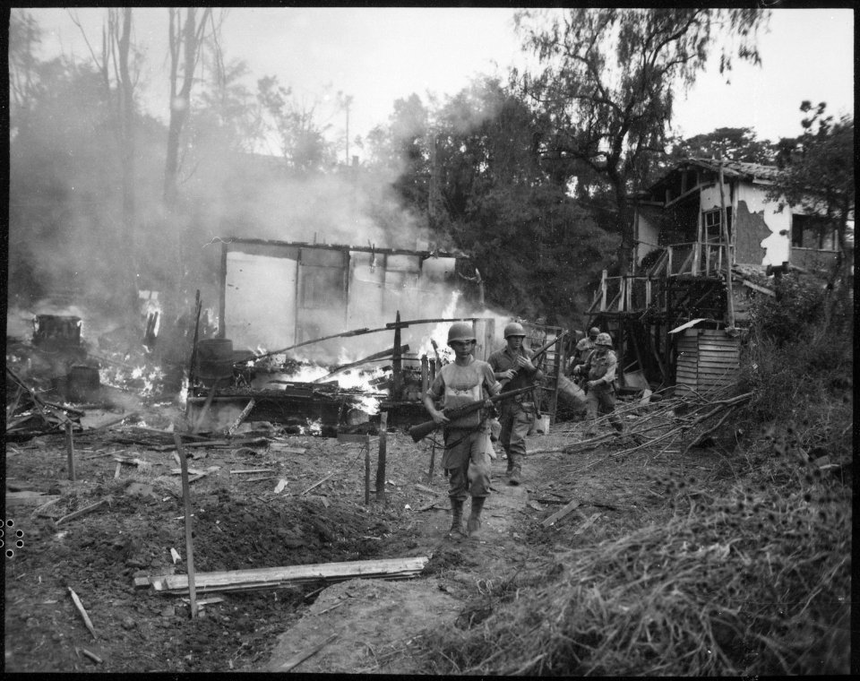 Leathernecks lead patrol between destroyed buildings in mop-up of Wolmi Island, gateway to Inchon. - NARA - 532400