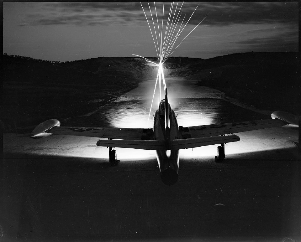 Leaving a fiery trail, .50 caliber bullets streak through the night as maintenance men of the 49th Fighter Bomber... - NARA - 542246