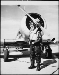 Lieutenant (junior grade) Robert Taylor, US Naval Reserve, standing beside a Navy trainer at a West Coast Naval Air... - NARA - 521012