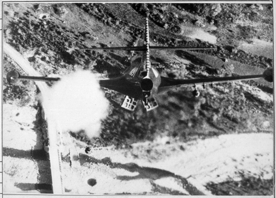 Lieutenant R. P. Yeatman, from the USS Bon Homme Richard, is shown rocketing and bombing Korean bridge. - NARA - 521000