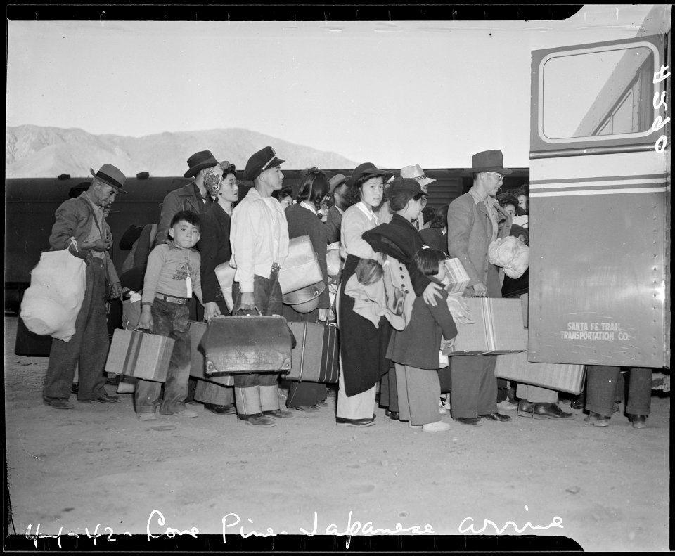 Lone Pine, California. Evacuees of Japanese ancestry arrive here by train and await buses for Manza . . . - NARA - 536231