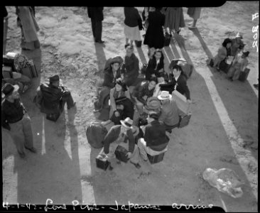 Lone Pine, California. Evacuees of Japanese ancestry arrive here by train and await buses for Manza . . . - NARA - 536241