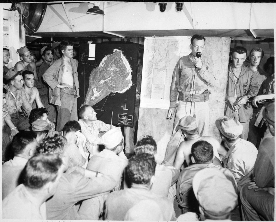 Lieutenant Wade discusses overall importance of target at pre-invasion briefing. Invasion of Iwo Jima, circa February... - NARA - 532364