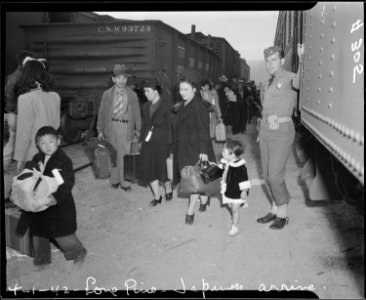 Lone Pine, California. Evacuees of Japanese ancestry arrive here by train and await buses for Manza . . . - NARA - 536244