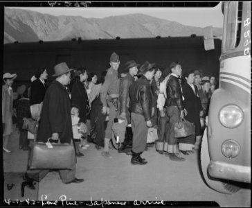 Lone Pine, California. Evacuees of Japanese ancestry arrive here by train and await buses for Manza . . . - NARA - 536232