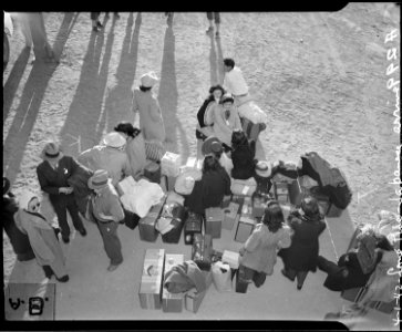 Lone Pine, California. Evacuees of Japanese ancestry wait for bus to War Relocation Authority cente . . . - NARA - 536238