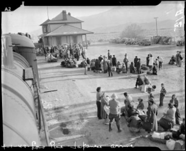Lone Oine, California. Evacuees of Japanese ancestry waiting to board buses which will take them to . . . - NARA - 536011