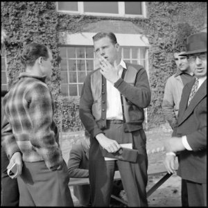 Los Angeles, California. Lockheed Employment. An appilcant waiting in line with his honorable discharge from the Navy... - NARA - 532211 photo