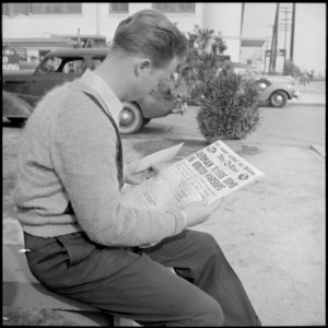 Los Angeles, California. Lockheed Employment. Cause and Effect. This young man reading the war news holds an... - NARA - 532213 photo