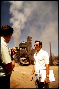 LOU DOOLEY, REGISTERED SANITARIAN WITH AIR POLLUTION CONTROL BOARD, TALKS WITH THE OWNER OF AN - NARA - 542546