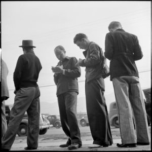 Los Angeles, California. Lockheed Employment. Holding their places in the waiting line by making out the preliminary... - NARA - 532203