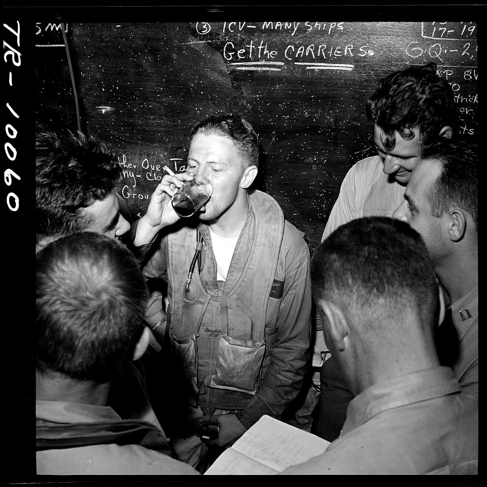 Lt. Ronald P. Rip Gift (center) and other pilots in ready room of USS Monterey CVL-26. - NARA - 520949