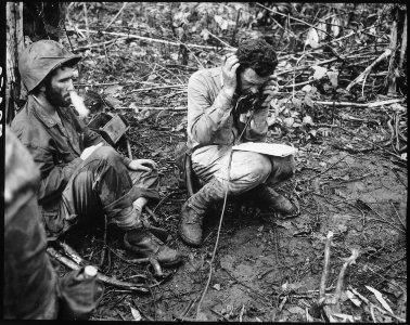 Ltieutenant Colonel John Weber, commanding officer of a Marine battalion on Cape Gloucester, sitting on his helmet... - NARA - 532523
