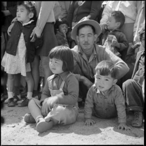Manzanar Relocation Center, Manzanar, California. A group of evacuee watching a Memorial Day Servic . . . - NARA - 538553
