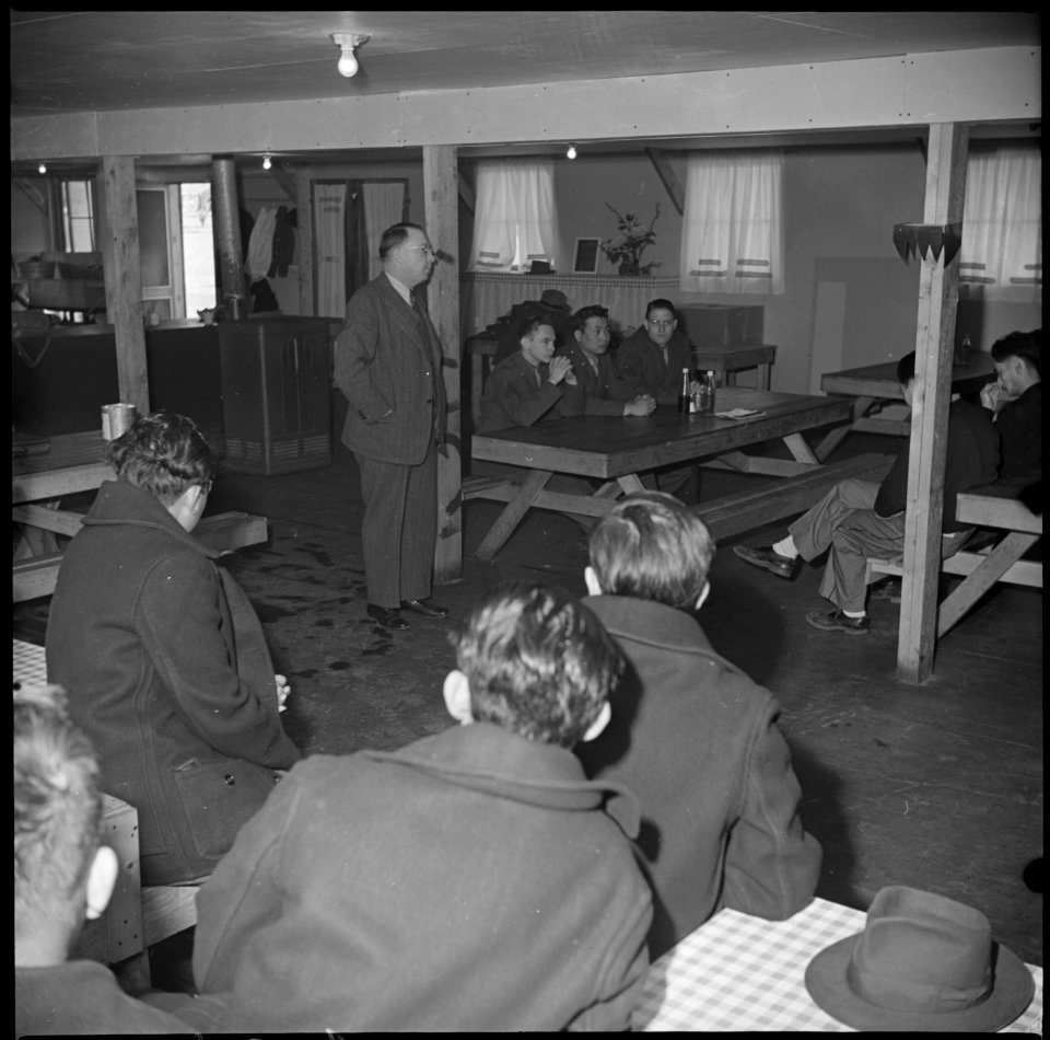 Manzanar Relocation Center, Manzanar, California. A meeting was held in one of the mess halls to ex . . . - NARA - 536713