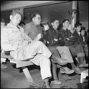 Manzanar Relocation Center, Manzanar, California. A group of residents of Japanese descent listenin . . . - NARA - 536712