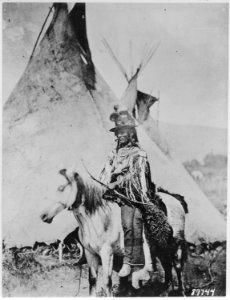 Looking Glass, a Nez Perce' chief, on horseback in front of a tepee, 1877 - NARA - 530914 photo