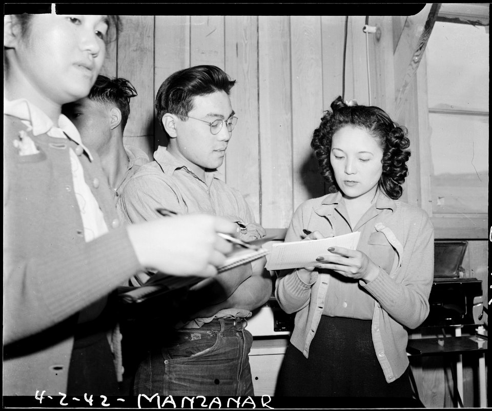 Manzanar Relocation Center, Manzanar, California. Evacauee clerk obtaining personal data from evacu . . . - NARA - 536864