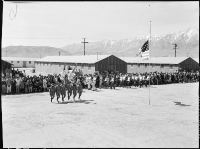 Manzanar Relocation Center, Manzanar, California. Evacuees of Japanese ancestry watch Memorial Day . . . - NARA - 538503