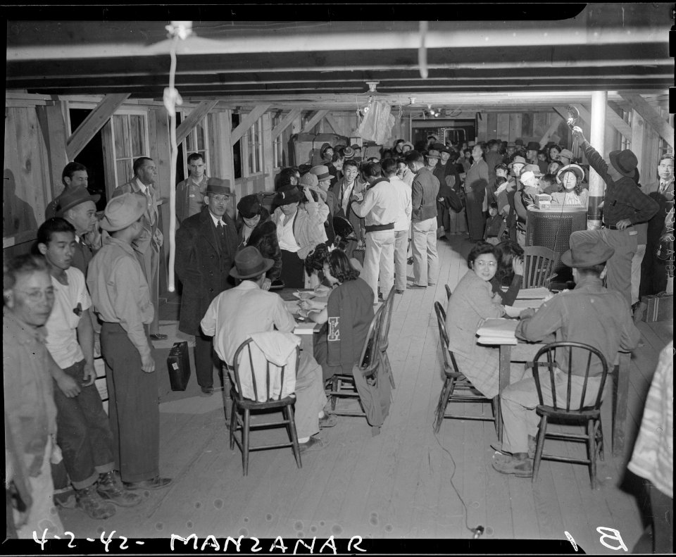 Manzanar Relocation Center, Manzanar, California. Evacuees of Japanese ancestry check in at Manzana . . . - NARA - 536752