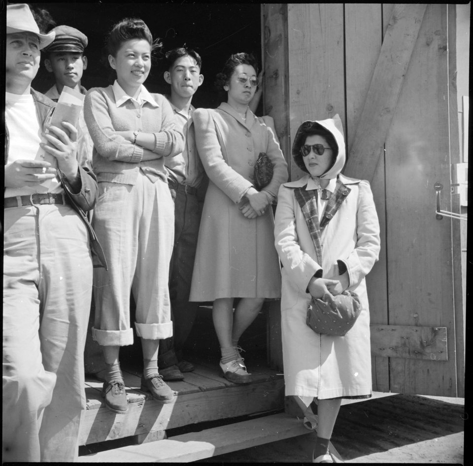 Manzanar Relocation Center, Manzanar, California. Evacuees of Japanese ancestry watch Memorial Day . . . - NARA - 538548