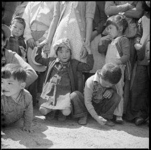 Manzanar Relocation Center, Manzanar, California. Evacuees of Japanese ancestry watching Memorial D . . . - NARA - 538541