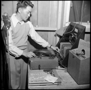 Manzanar Relocation Center, Manzanar, California. Henry Ushijima, formerly a sound engineer in Holl . . . - NARA - 538572