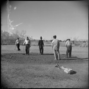 Manzanar Relocation Center, Manzanar, California. Golfing enthusiasts enjoy a friendly game of golf . . . - NARA - 536943
