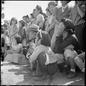 Manzanar Relocation Center, Manzanar, California. Evacuees of Japanese ancestry watching Memorial D . . . - NARA - 538540