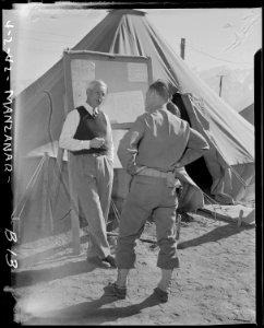Manzanar Relocation Center, Manzanar, California. Lieutenant Harvey H. Severson (right) of (the) mi . . . - NARA - 536762