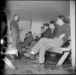 Manzanar Relocation Center, Manzanar, California. Lt. Eugene Bogard explaining the purpose of regis . . . - NARA - 536708