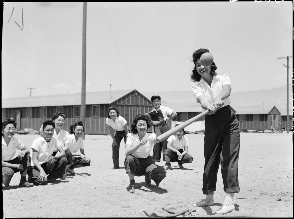 Manzanar Relocation Center, Manzanar, California. Maye Noma behind the plate and Tomi Nagao at bat . . . - NARA - 538498