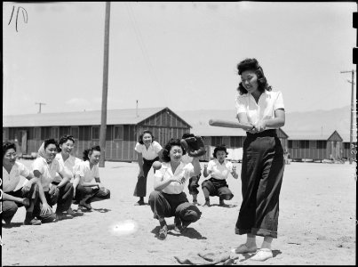 Manzanar Relocation Center, Manzanar, California. Maye Noma behind the plate and Tomi Nagao at bat . . . - NARA - 538499