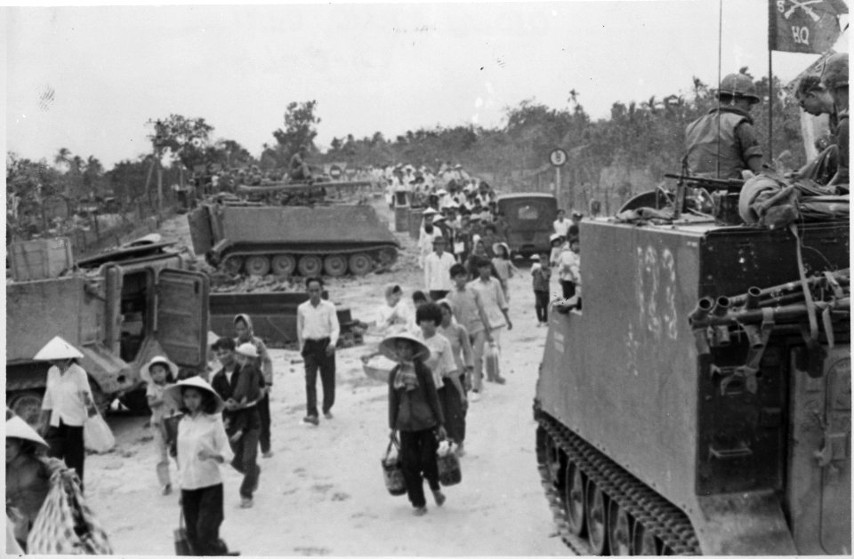 M-113 armored personnel carriers stand by as Vietnamese refugees evacuate the village of My Tho, Dinh Tuong Province... - NARA - 531451