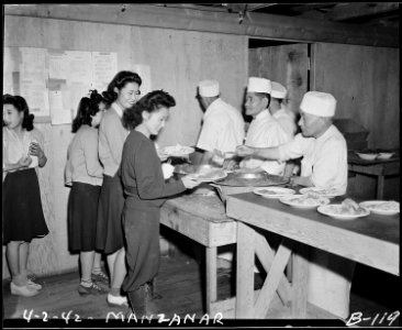Manzanar Relocation Center, Manzanar, California. Mealtime shortly after arrival in April 1942 of f . . . - NARA - 536867