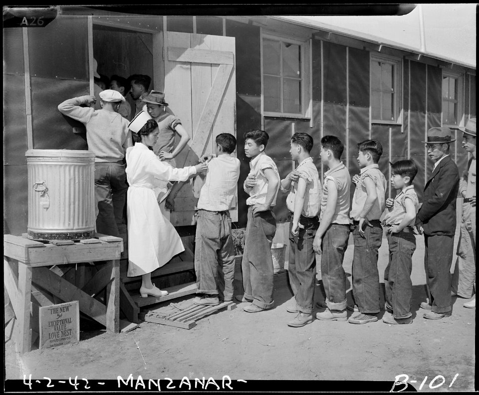Manzanar Relocation Center, Manzanar, California. New arrivals waiting their turn to be vaccinated . . . - NARA - 536850