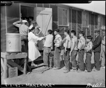 Manzanar Relocation Center, Manzanar, California. New arrivals waiting their turn to be vaccinated . . . - NARA - 536850