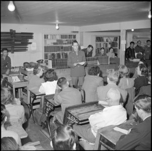 Manzanar Relocation Center, Manzanar, California. Sergeant Victor Tierman explaining the registrati . . . - NARA - 536717