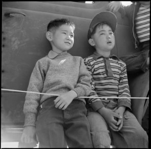 Manzanar Relocation Center, Manzanar, California. Two small evacuees of Japanese descent at Memoria . . . - NARA - 538546