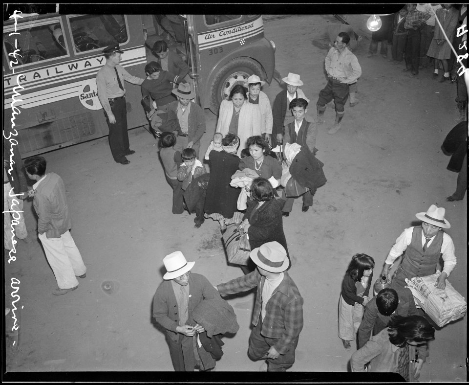 Manzanar, California. Evacuees of Japanese ancestry arrive by bus from Lone Pine. They were taken . . . - NARA - 536230