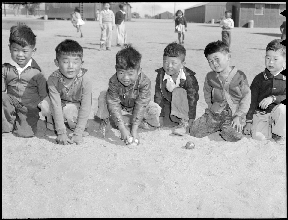 Manzanar Relocation Center, Manzanar, California. These youngsters are playing in the field of a nu . . . - NARA - 538487