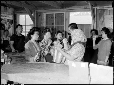 Manzanar Relocation Center, Manzanar, California. Time out for refreshments in community store at M . . . - NARA - 538495