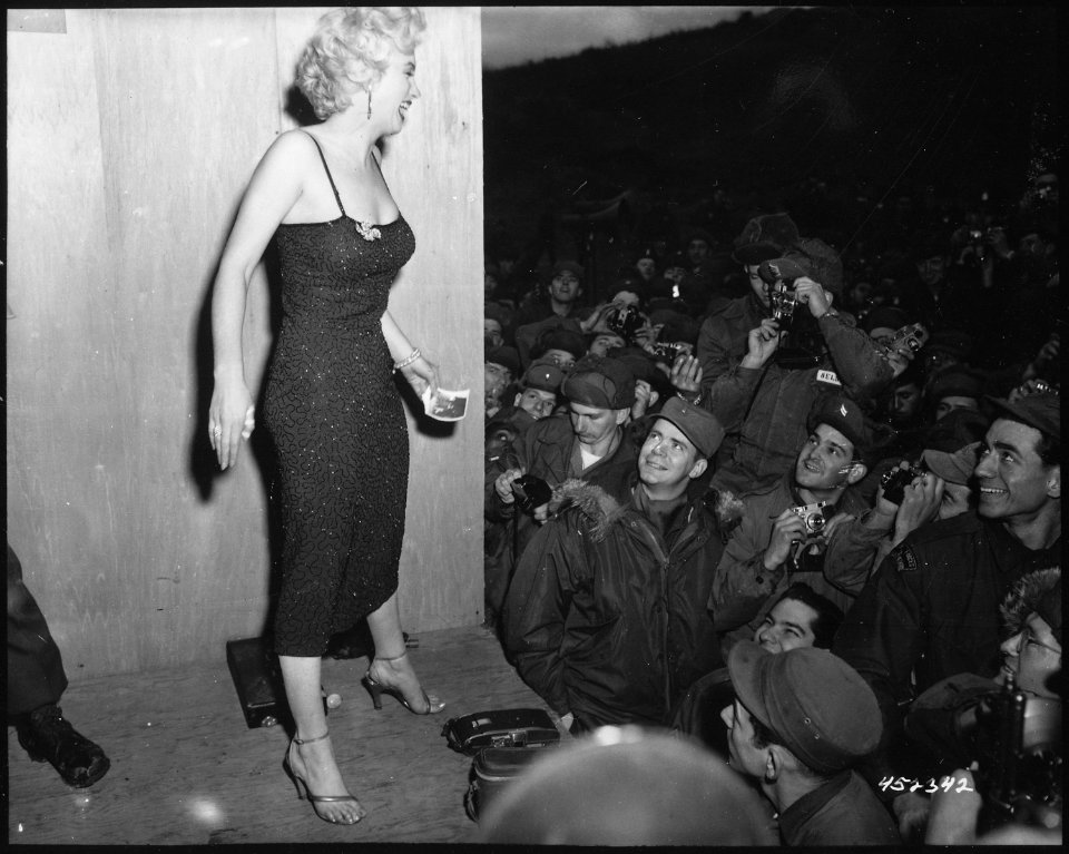 Marilyn Monroe, motion picture actress, appearing with the USO Camp Show, Anything Goes, poses for the shutterbugs... - NARA - 531435