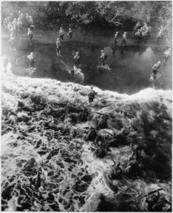 Marines hit three feet of rough water as they leave their LST to take the beach at Cape Gloucester, New Britain. - NARA - 532520