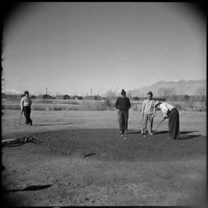 Manzanar Relocation Center, Manzanar, California. Golfing enthusiasts enjoy a friendly game of golf . . . - NARA - 536944