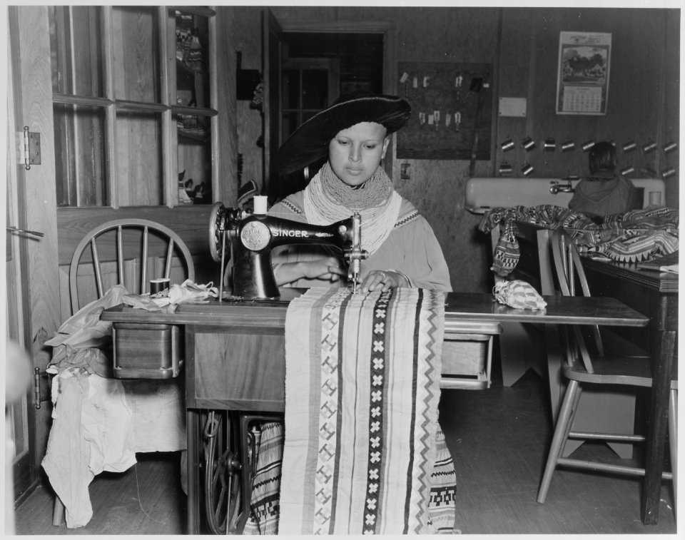 Mary Parker, a young Seminole girl, using sewing machine at the Brighton Day School on the Glades County Reservation, Fl - NARA - 519170