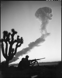 Marines Participate in A-Bomb Tests - Two Marine infantrymen, at a machine gun emplacement, are silhouetted against... - NARA - 532468